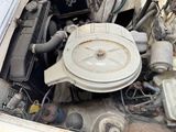 an old car engine with the hood open