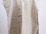 a white shirt hanging on a hanger in a room