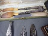 a box that has a knife, spoon, and spoon rest in it