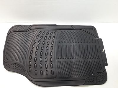 a close up of a black rubber floor mat on a white surface