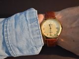 a man wearing a watch on his wrist with his hand on his wrist