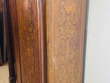 a wooden cabinet in the corner of a room