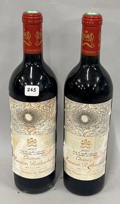 two bottles of red wine sitting next to each other on a table