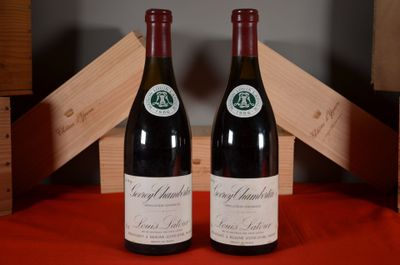two bottles of wine sitting next to each other on a table
