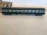 a green and white train car sitting on a table