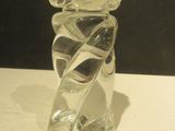 a glass vase with a flower on it on a table