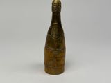an antique brass bottle of champagne on a white background
