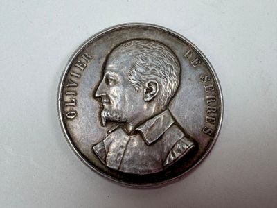 une pièce d'argent sur laquelle figure l'image d'un homme