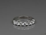a close up of a diamond ring on a reflective surface