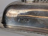 a close up of a silver plate on a table