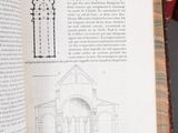 an open book with a drawing of a building on it