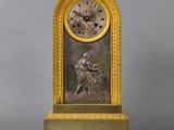 an image of a gold clock with a man on a horse