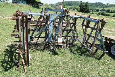 a lot of old farm equipment in the field
