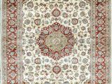 an ivory and red rug with a medallion design