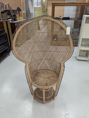 a wicker chair that is on display in a store