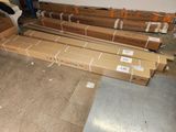 many boxes of cardboard sitting on the floor in a room