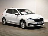 the white car is parked in a room with a checkered floor