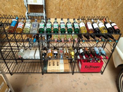 many bottles of alcohol sitting on a rack in a room