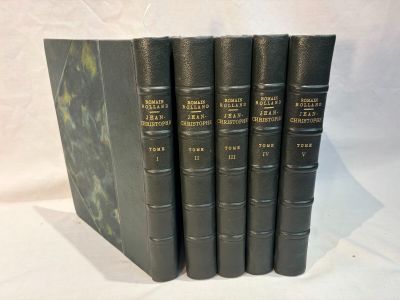 five black books are lined up in a row on a white surface