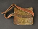 a brown leather bag with a bird emblem on it
