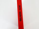 a red tube that has a stick on it