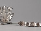 a silver plate with a bunch of metal objects on it