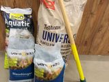 two bags of food and a shovel on the counter