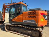 an orange excavator that is parked in the dirt