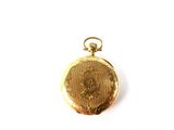 a gold pocket watch with a picture of a woman on it