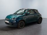 a blue smart car parked in a room with a white wall