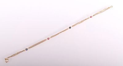 a gold bracelet with multi colored stones on a white background