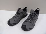 pair of gray and black shoes on a white surface