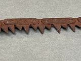 an old rusty saw that is on a table