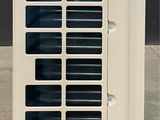 a white air conditioner sitting on the ground
