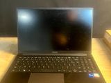 a laptop computer sitting on top of a wooden table