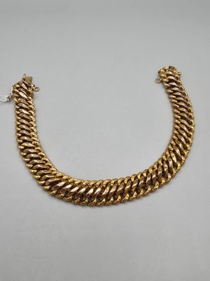 a gold chain bracelet with a clasp on a white background