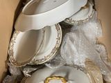 many plates and bowls in a cardboard box