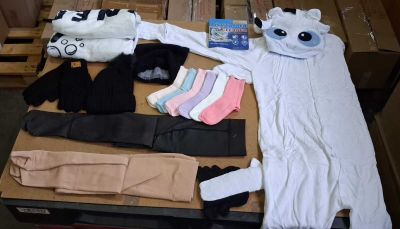 a table with a lot of clothing and a stuffed animal