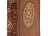 un vieux livre relié en cuir, orné de dorures et doté d'une couverture décorative
