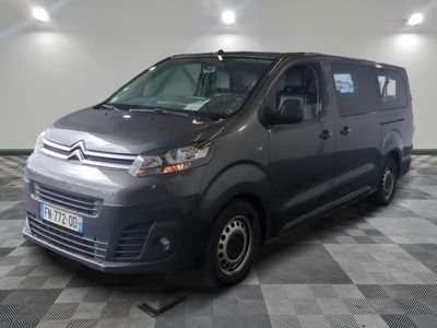 the grey van is parked in the garage on the checkered floor