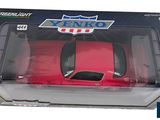 a red toy car in a box on a white background
