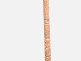 a tall wooden pole that is standing up on a table