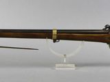 an old rifle with a wooden barrel and a wooden handle
