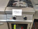 a stainless steel stove and sink in a kitchen