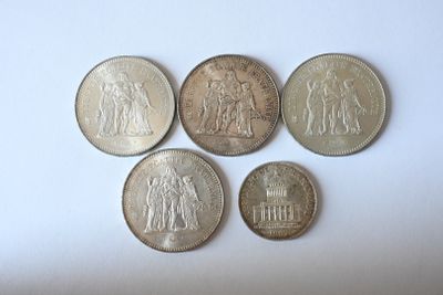 six different types of coins are shown on a white surface