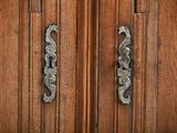 a close up of a door handle on a wooden door