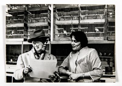black and white photograph of a man and a woman looking at a piece of paper