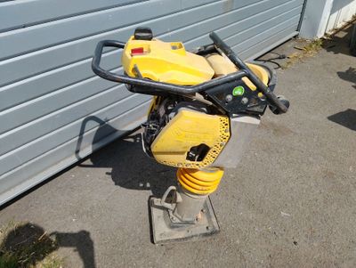 a yellow and black motor bike parked next to a garage