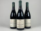 three bottles of wine sitting next to each other on a table