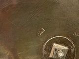 a silver plate with numbers on it on a table